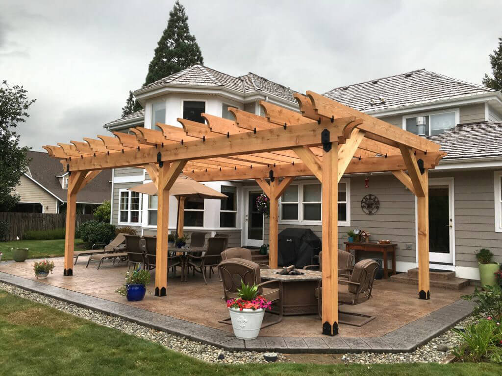 Pergola with an open slatted roof over a landscaped Denver patio